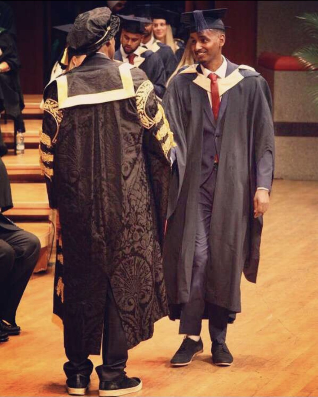 graduation picture of me shaking hands with Lenny Henry